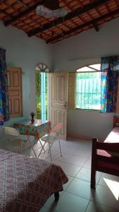 a room with a bed and a table and chairs at Hostel Ariramba in Belém +11 photos