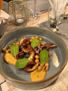 a plate of food with meat and vegetables on a table at Cozy 1 Bedroom Apt with Pool & 3mins Walk to Beach - TRR4 in Pointe aux Canonniers