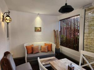 a living room with a couch and a table at Cozy 1 Bedroom Apt with Pool & 3mins Walk to Beach - TRR4 in Pointe aux Canonniers