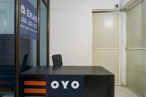 a black desk with an ovo sign on it at Hotel O EKAB Hospitality in Mundhwa