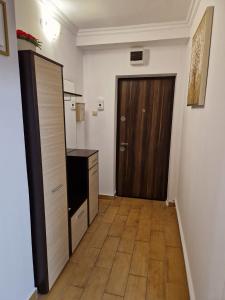 a hallway with a door and a wooden floor at Riverside Central Apartment in Satu Mare