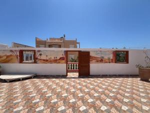 a building with a painting on the side of it at Berber RIAD with big terrace in Aourir