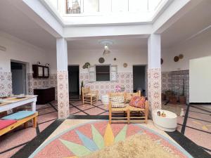 a living room with a table and chairs at Berber RIAD with big terrace in Aourir