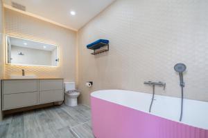 a bathroom with a large tub and a toilet at Stylish Eco Villa Sunset Garden 1E with Private Pool near Nai Harn Beach in Ban Saiyuan (1)