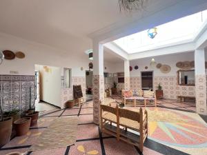 a living room with a table and chairs in it at Berber RIAD with big terrace in Aourir