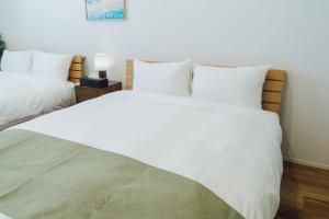 Postel nebo postele na pokoji v ubytování Lohas Resort 芥屋B