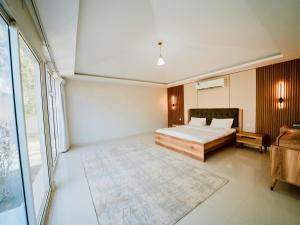 a bedroom with a bed and a large window at Seven Elements Resort in Ras al Khaimah +25 photos