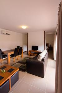 a living room with a couch and a table at Sítio da Assumada in Lajes das Flores