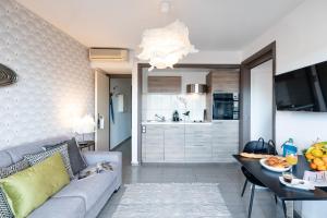 a living room with a couch and a table at Sweett - Maison Blanche I in Juan-les-Pins