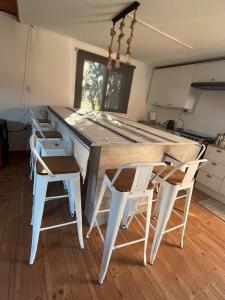 a kitchen with a table and four chairs at Maitencillo, amplía y cómoda casa, con piscina y hoy tub in Puchuncaví
