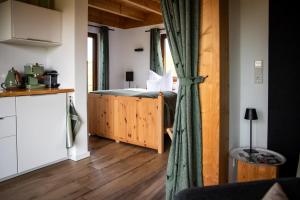 a bedroom with a bed and a wooden floor at Chalet Landsitz in Dippoldiswalde
