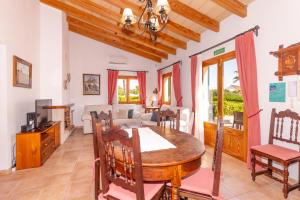 a dining room and living room with a table and chairs at Villa Cas Frares by Slow Villas in Consell +55 photos