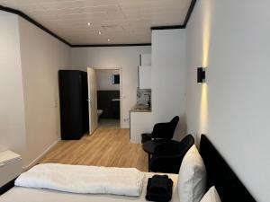 a room with a bed and two chairs in it at RRR- Room Rental Rheine in Rheine