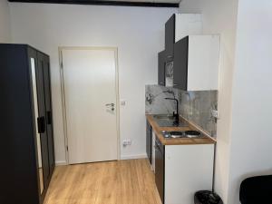 a small kitchen with a sink and a stove at RRR- Room Rental Rheine in Rheine
