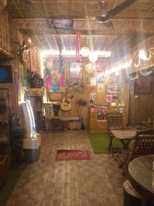 a room with a music room with a table and chairs at Happy Shiva Cefe & Homestay in Rishīkesh