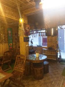 a room with a table and chairs in a restaurant at Happy Shiva Cefe & Homestay in Rishīkesh +2 photos