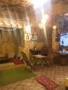 a living room with chairs and a table and a table and a table at Happy Shiva Cefe & Homestay in Rishīkesh