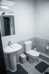 a bathroom with a toilet and a sink at Korkem Tau Hotel in Astana +5 photos