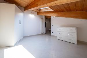 a large room with a wooden ceiling and a dresser at NAP Luxury Apartment in Naples +2 photos