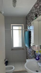 a bathroom with a sink and a tub and a window at Holiday season at sea in Shëngjin +75 photos