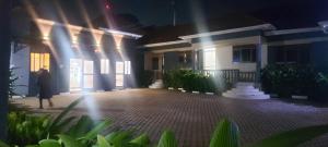 a person walking in front of a house at night at SEVEN J's SUITES in Seeta