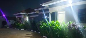 a row of houses at night with a purple light at SEVEN J's SUITES in Seeta
