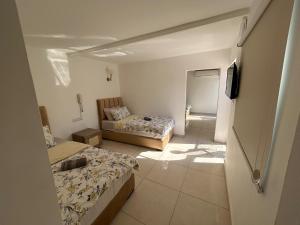 a small room with two beds and a mirror at Zaman Ya Zaman Boutique Hotel in Amman +90 photos