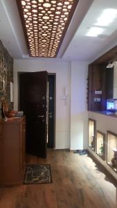 a living room with a black door and a fireplace at Appartement des Palmiers in Biskra