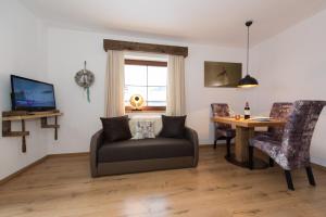 a living room with a couch and a table at Angelas Appart in Ehrwald