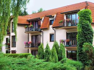 un bâtiment avec des balcons et des plantes devant dans l'établissement Hotel und Restaurant Sackwitzer Mühle, à Bad Schmiedeberg