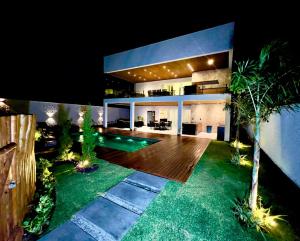 a house with a pool in the middle of a yard at Uhane Grand Villa 7 Quartos, Piscina e Vista Mar in São Miguel do Gostoso