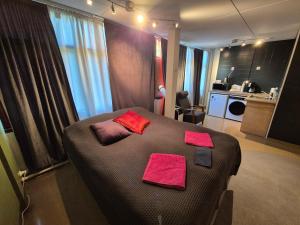 a bedroom with a bed with pink towels on it at NATO bunker with nice bed and appliancies in Mikkeli