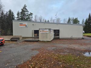 a building that is sitting in a parking lot at NATO bunker with nice bed and appliancies in Mikkeli