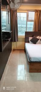 a bedroom with a bed and a window at Hotel airport stay heavens in kolkata