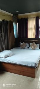 a large bed in a room with curtains at Hotel airport stay heavens in kolkata