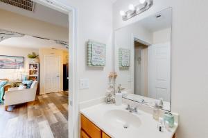 a bathroom with a sink and a mirror at Crystal Beach 3BR Comfortable Home w/ Patio, Short Drive to Beach in Crystal Beach +21 photos