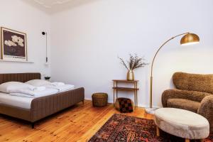 a living room with a couch and a chair at Berlin & Friends in Berlin +8 photos