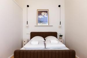 a bedroom with a bed with two pillows on it at Berlin & Friends in Berlin