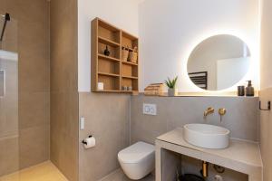 a bathroom with a toilet and a sink and a mirror at Berlin & Friends in Berlin