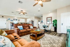 a living room with a couch and a table at Stunning Beachfront Dog Friendly Sleeps 8 in Caplen