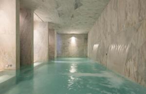 a room with a pool of water in a building at Lisboa Pessoa Hotel in Lisbon
