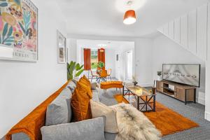 a living room with a couch and a tv at Clover House Stunning Cosy Cottage 3BR By AltoLuxo Short Lets & Serviced Accommodation With Free WiFi & Parking in Ebbw Vale