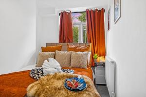 a bedroom with a bed with a plate of food on it at Clover House Stunning Cosy Cottage 3BR By AltoLuxo Short Lets & Serviced Accommodation With Free WiFi & Parking in Ebbw Vale