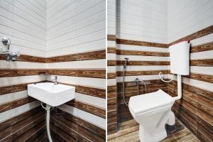 a bathroom with wooden walls and a toilet and a sink at Super Hotel O Rudra palace in Jaipur