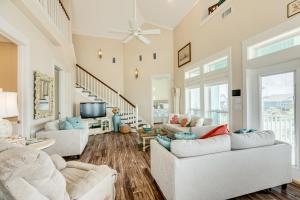 a living room with two couches and a tv at Exclusive Pool Gulf Views Modern Cargo Lift in Bolivar Peninsula