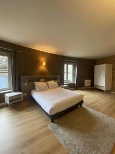 a bedroom with a large bed with white sheets at Château de Flixecourt in Flixecourt