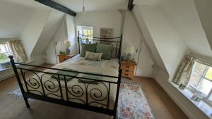 a bedroom with a large bed in a attic at 8 Pudding Bag Lane in Exton