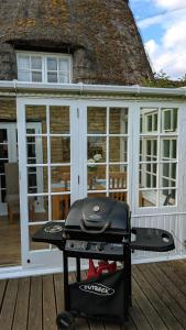 a grill on a deck in front of a house at 8 Pudding Bag Lane in Exton +1 photo
