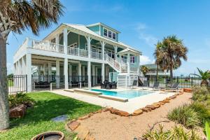 a large white house with a swimming pool at Exclusive Pool Gulf Views Modern Cargo Lift in Bolivar Peninsula