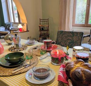 a table with food and dishes on top of it at La Maison de Marie in Les Rouges-Eaux